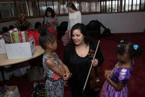 Houston Symphony Community-Embedded Musician Jenna Barghouti (violin) chats with two of the unmatched "littles" from Big Brothers Big Sisters.